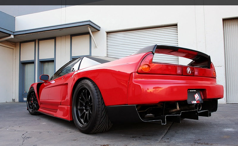 Red Acura NSX rear angle view with aftermarket rear wing, diffuser, and wide stance, modified performance car build