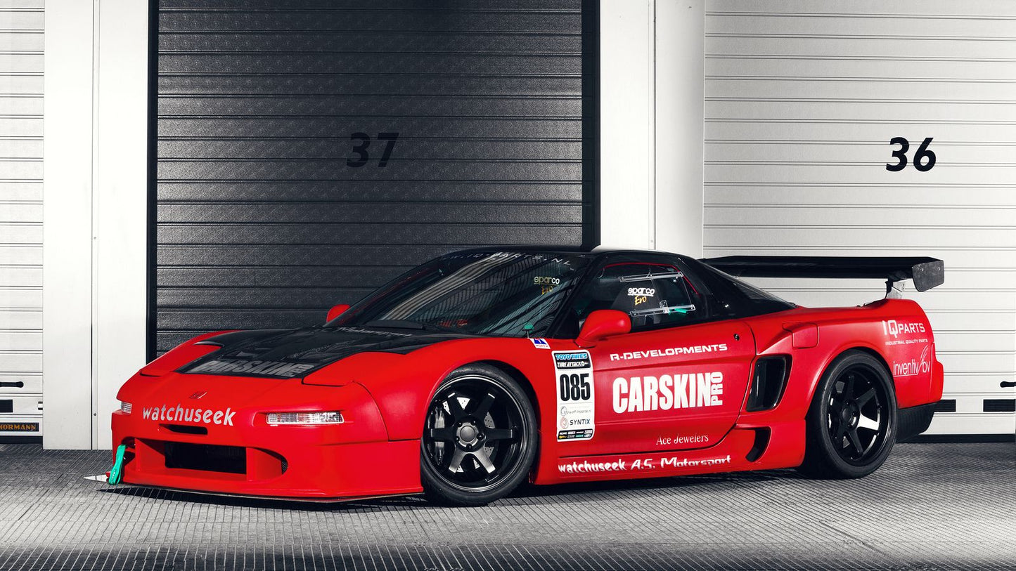 Red Acura NSX widebody race car side view with custom aero kit, lowered stance, and track-ready performance build