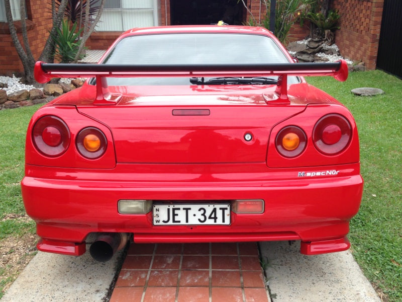 Red Nissan Skyline R34 with JSAI Aero rear wing performance aero body kit