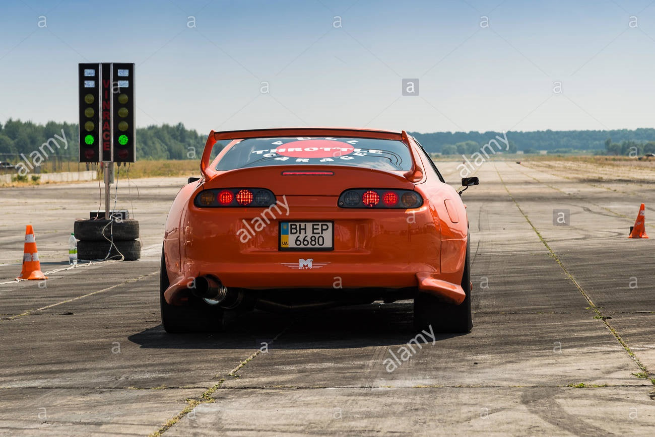 Toyota Supra drag racing car preparing for race, high-performance modified vehicle on track with racing setup
