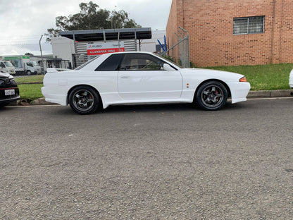 Modified Nissan Skyline GT-R equipped with JSAI AERO front bumper, side skirts and rear aero kit, enhancing aggressive styling and aerodynamic performance.