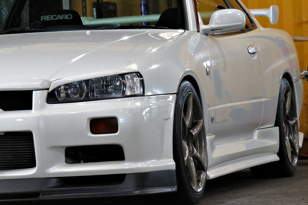 Nissan Skyline GT-R R34 with JSAI AERO front bumper, side skirts, and rear aero enhancements.