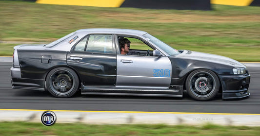 Nissan Skyline R34 with JSAI AERO front bumper, side skirts, and rear aero enhancements.