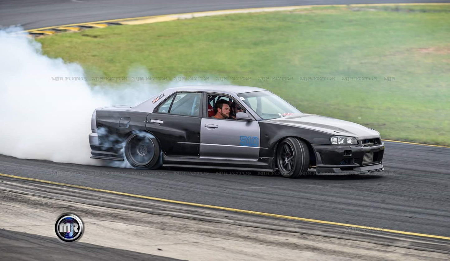 Nissan Skyline R34 with JSAI AERO front bumper, side skirts, and rear aero enhancements.