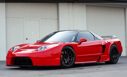 Red Acura NSX front angle view with widebody kit, aftermarket wheels, and lowered stance, modified performance car build