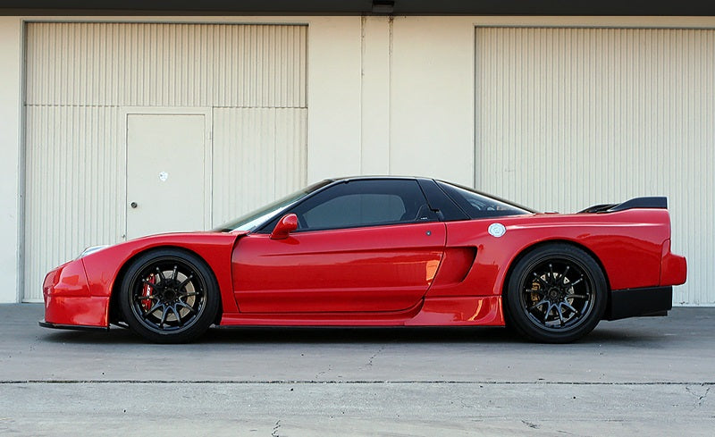 Red Acura NSX side profile with widebody kit, aftermarket wheels, and lowered stance, modified performance car build