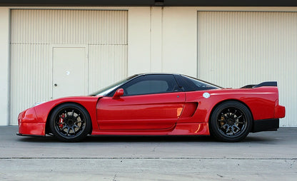Red Acura NSX side profile with widebody kit, aftermarket wheels, and lowered stance, modified performance car build