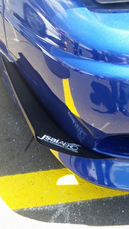 Close-up of JSAI Aero front lip corner installed on a blue Nissan Skyline bumper