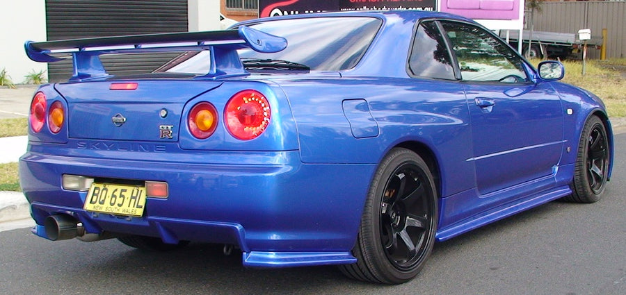 Rear angle view of blue Nissan Skyline R34 with JSAI Aero body kit