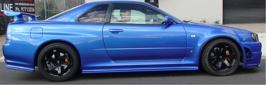 Side view of blue Nissan Skyline R34 with JSAI Aero body kit
