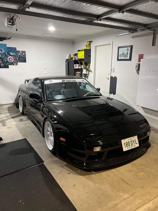 Black Nissan Silvia S13 with JSAI Aero performance body kit and aero parts installed in garage