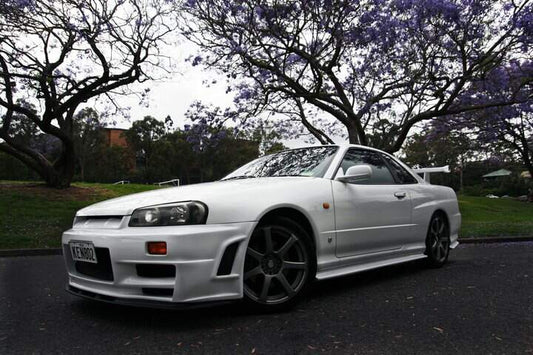 White Nissan Skyline GT-R R34 with JSAI Aero front bumper and side skirts performance aero body kit