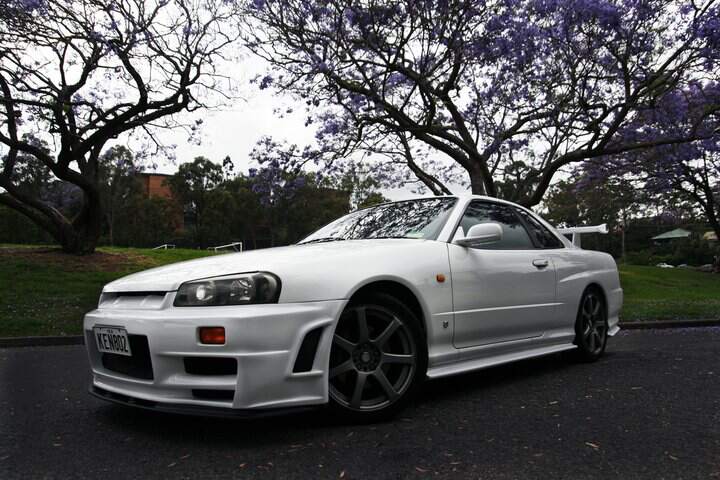 White Nissan Skyline GT-R R34 with JSAI Aero front bumper and side skirts performance aero body kit