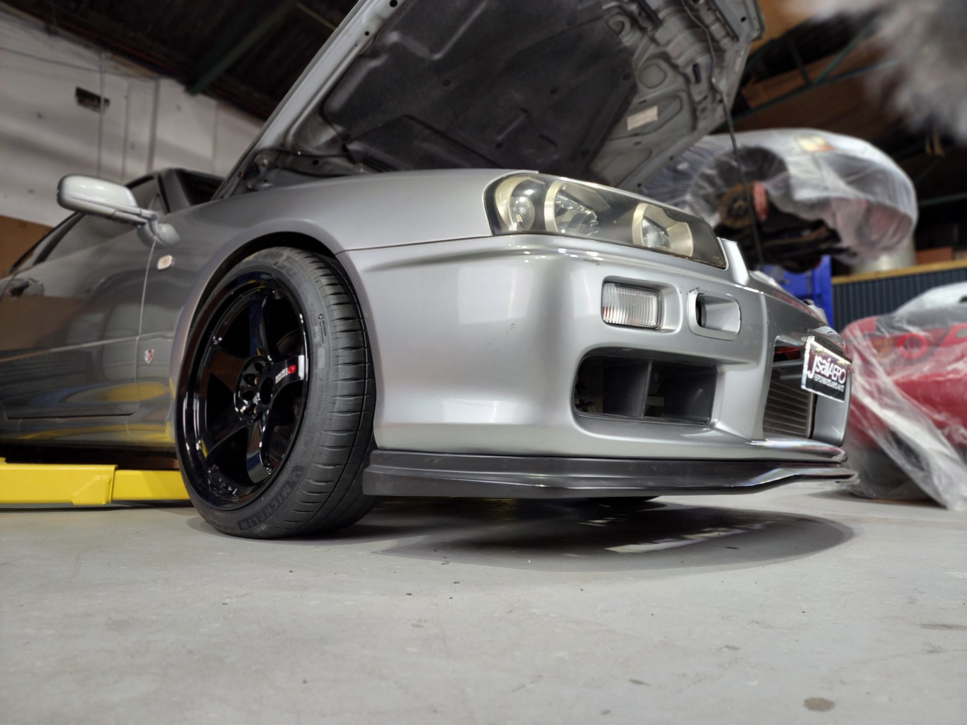 Silver Nissan Skyline GT-R R34 with JSAI Aero front lip performance aero body kit