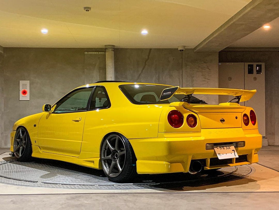 Yellow Nissan Skyline GT-R R34 with JSAI Aero rear wing and performance aero body kit