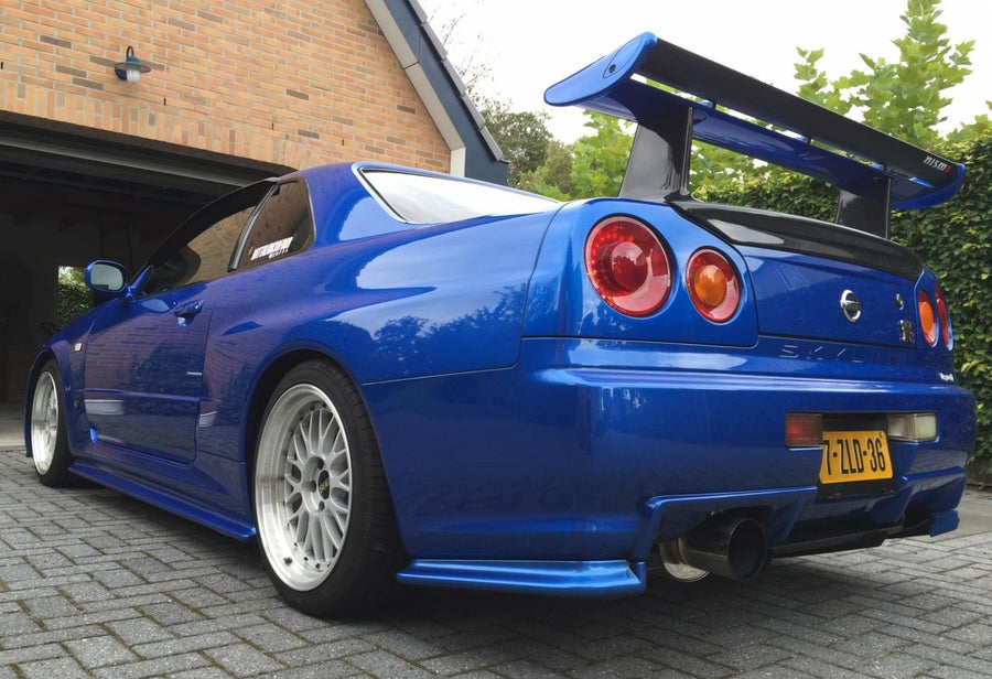 Blue Nissan Skyline GT-R R34 with JSAI Aero rear wing and performance aero body kit