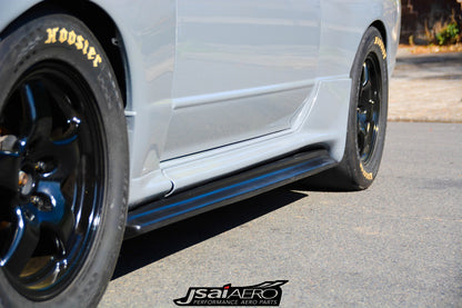 Close-up of JSAI Aero side skirt installed on a Nissan Skyline with black wheels and performance tires