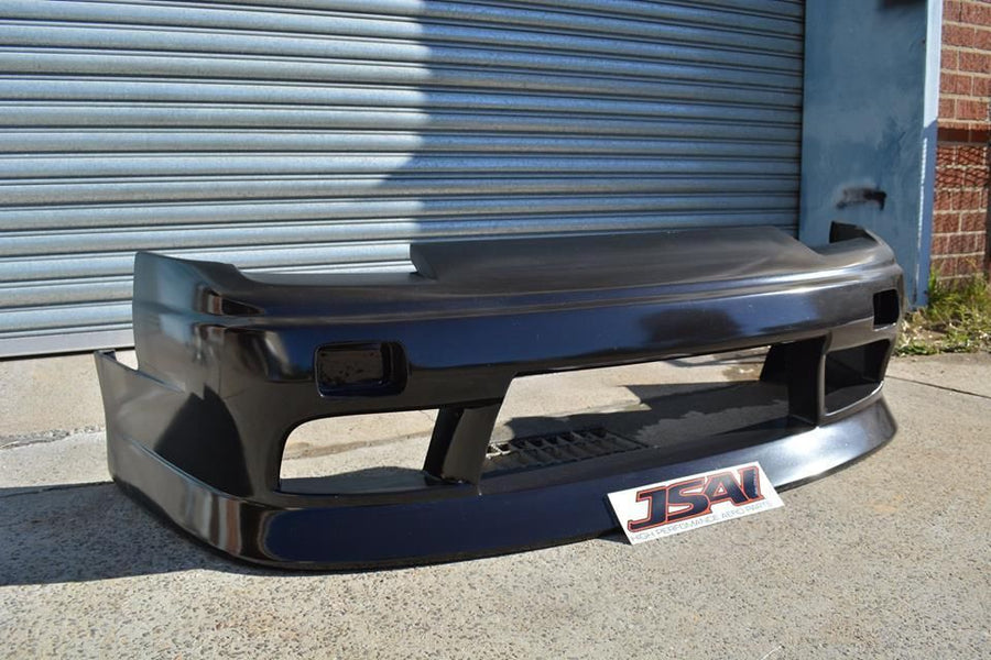 Black fibreglass front bumper bar for a performance car with large air intake openings