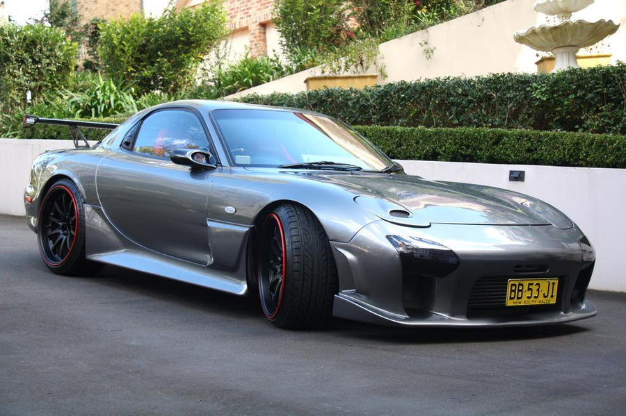 Grey Mazda RX-7 FD3S with JSAI Aero front lip and side skirts aftermarket body kit front angle view with rear wing