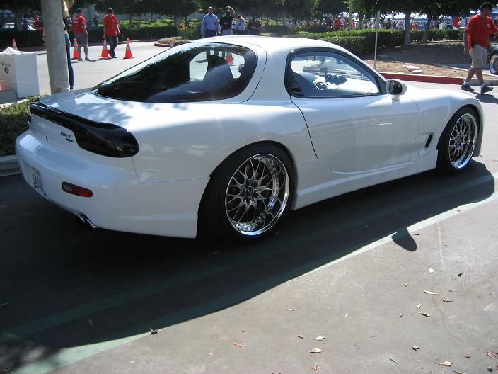 White Mazda RX-7 FD3S with JSAI Aero rear lip and side skirts aftermarket body kit rear angle view
