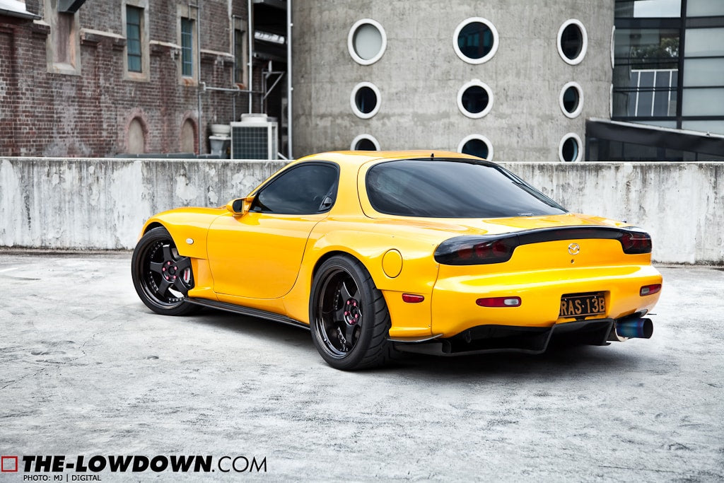 Yellow Mazda RX-7 FD3S with JSAI Aero rear lip and side skirts aftermarket body kit rear angle view
