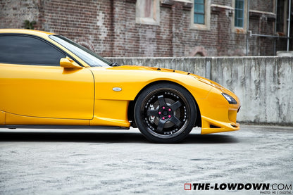 Close-up side view of yellow Mazda RX-7 FD3S with JSAI Aero side skirts installed aftermarket body kit detail