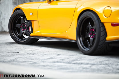 Low angle close-up of yellow Mazda RX-7 FD3S with JSAI Aero side skirts installed aftermarket body kit detail