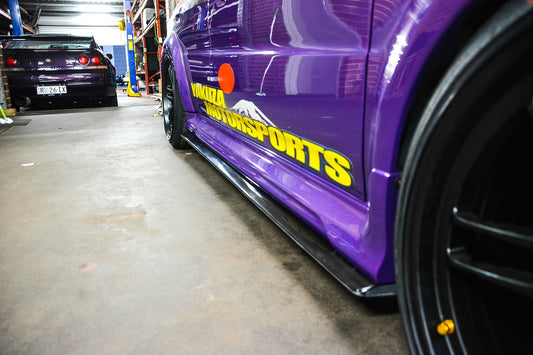 Rear angle view Mitsubishi Lancer Evolution 5 6 CP9A side skirt extensions aftermarket body kit installed