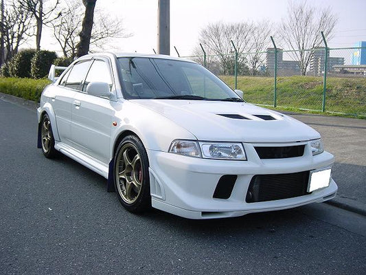 Front angle view Mitsubishi Lancer Evolution 6.5 TME with aftermarket front lip installed bumper upgrade