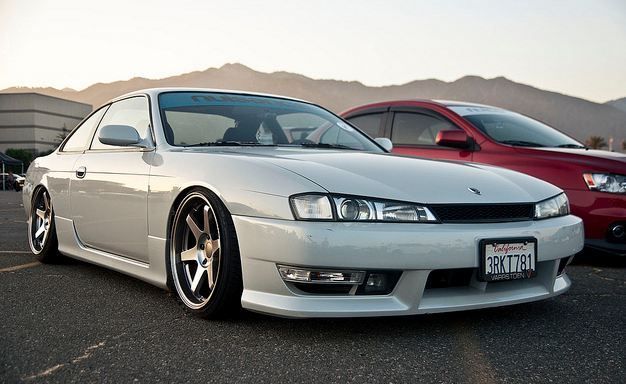 Nissan S14 Silvia 200SX lowered stance with aftermarket aero body kit front view
