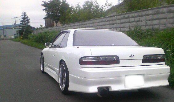 Rear view of Nissan S14 Silvia 200SX with aftermarket aero rear bumper and body kit