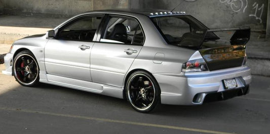 Rear angle view of silver Nissan S14 Silvia 200SX with Navan style side skirts aftermarket body kit installed