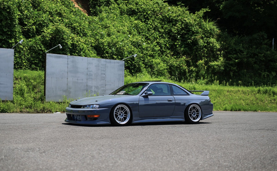 Nissan S14 Silvia 200SX with Vertex style aero kit and lowered stance side view