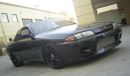 Front three-quarter view of black Nissan Skyline R32 GT-R with front mount intercooler