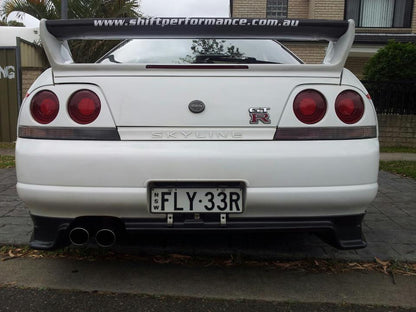Rear view of Nissan Skyline R33 GT-R with GT wing and aero rear spats