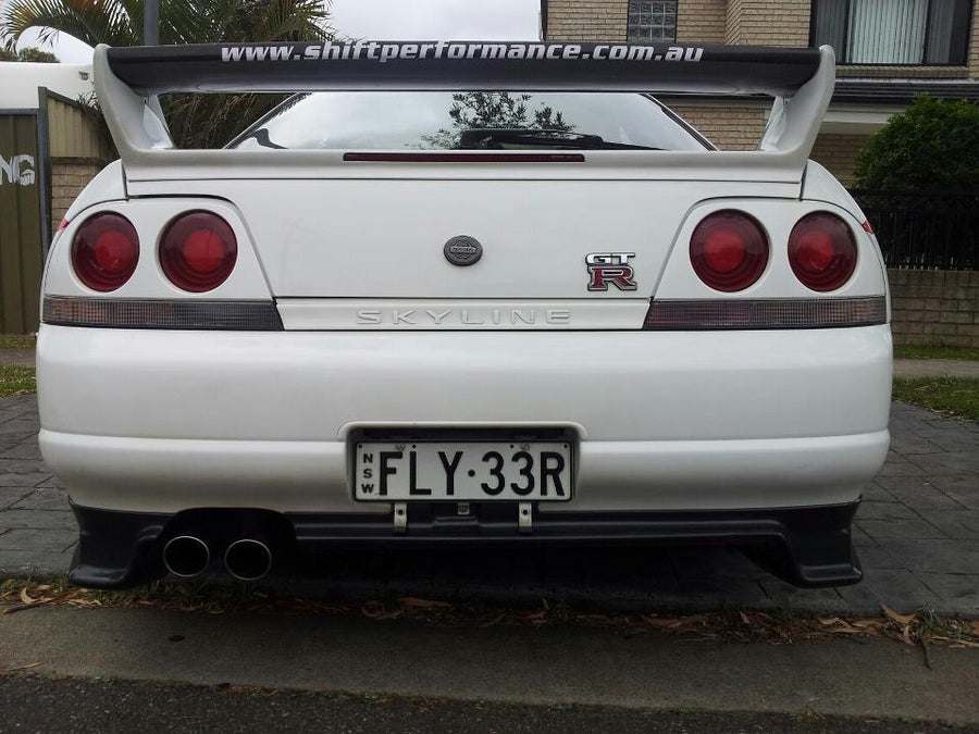 Rear view of Nissan Skyline R33 GT-R with GT wing and aero rear spats