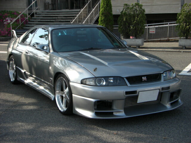 Front angle view of Nissan Skyline R33 GTS-T with aero body kit styling