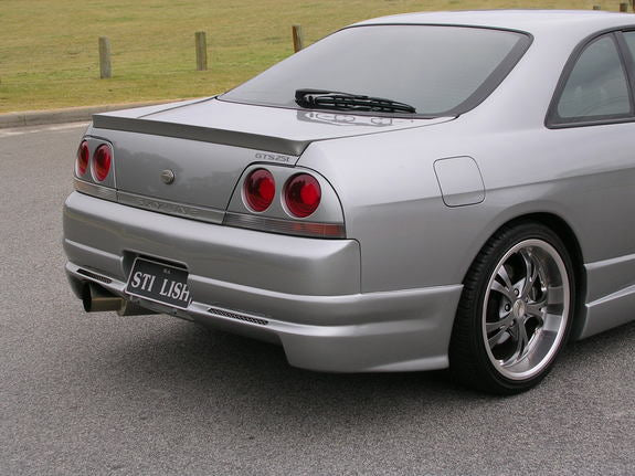 Rear angle view of Nissan Skyline R33 GTS-T with aero body kit styling