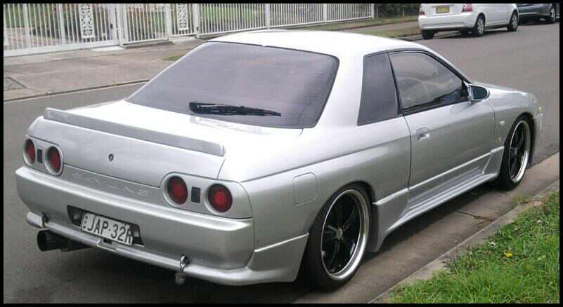 Rear angle view of Nissan Skyline R33 with aero body kit and trunk lip spoiler