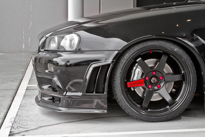 Close-up of Nissan Skyline R34 front bumper, wheel, and aero vent