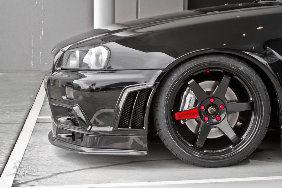 Close-up of Nissan Skyline R34 front bumper, wheel, and aero vent