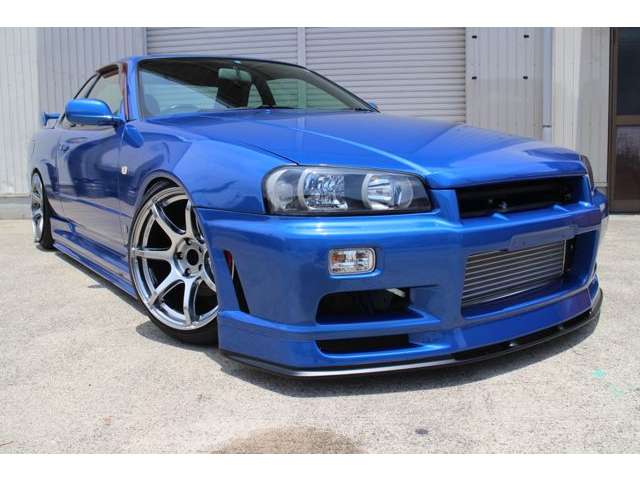 Blue Nissan Skyline GT-R R34 with JSAI Aero front bumper and performance aero body kit