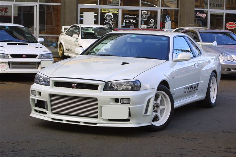 Front three-quarter view of white Nissan Skyline R34 GT-R with front mount intercooler