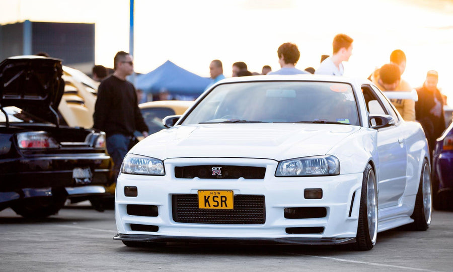 Front view of white Nissan Skyline R34 GT-R at car meet