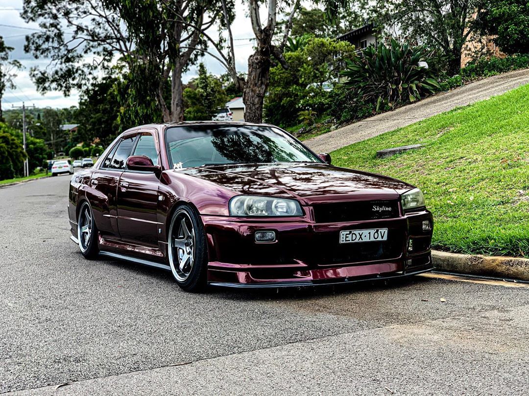 Nissan Skyline R34 with JSAI Aero body kit parked on street front view