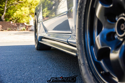 Close-up of Nissan Skyline side skirt aero part installed on a performance car with aftermarket wheels