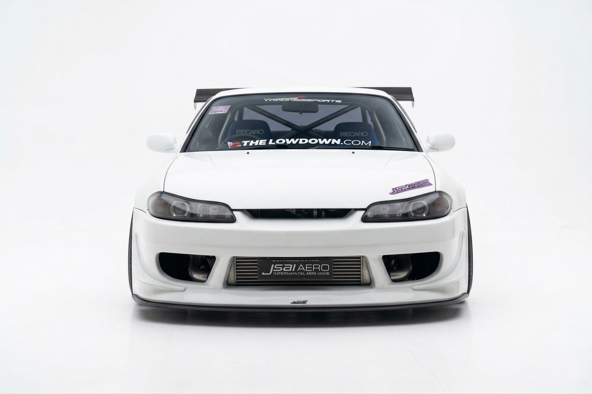 Front view of a white Nissan S15 Silvia with JSAI Aero front bumper, front lip, wide fenders, exposed intercooler and GT wing for JDM drift, street and track builds.