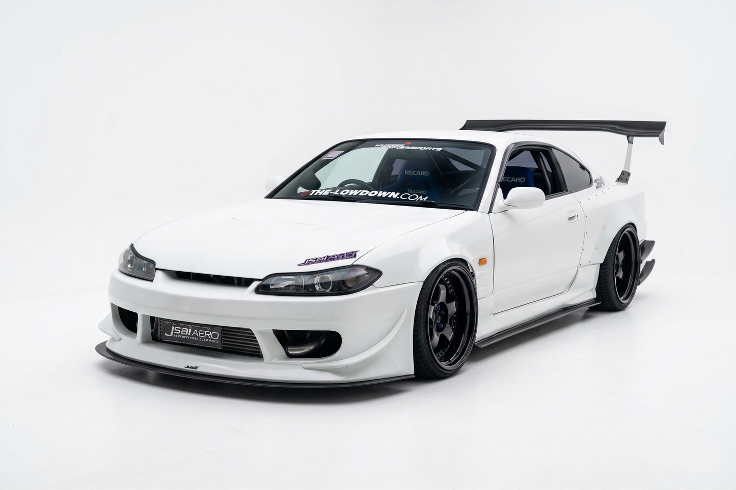 White Nissan S15 Silvia with JSAI Aero front bumper, front lip, side skirts, wide fenders, deep-dish wheels and GT rear wing for JDM drift, street and track builds.