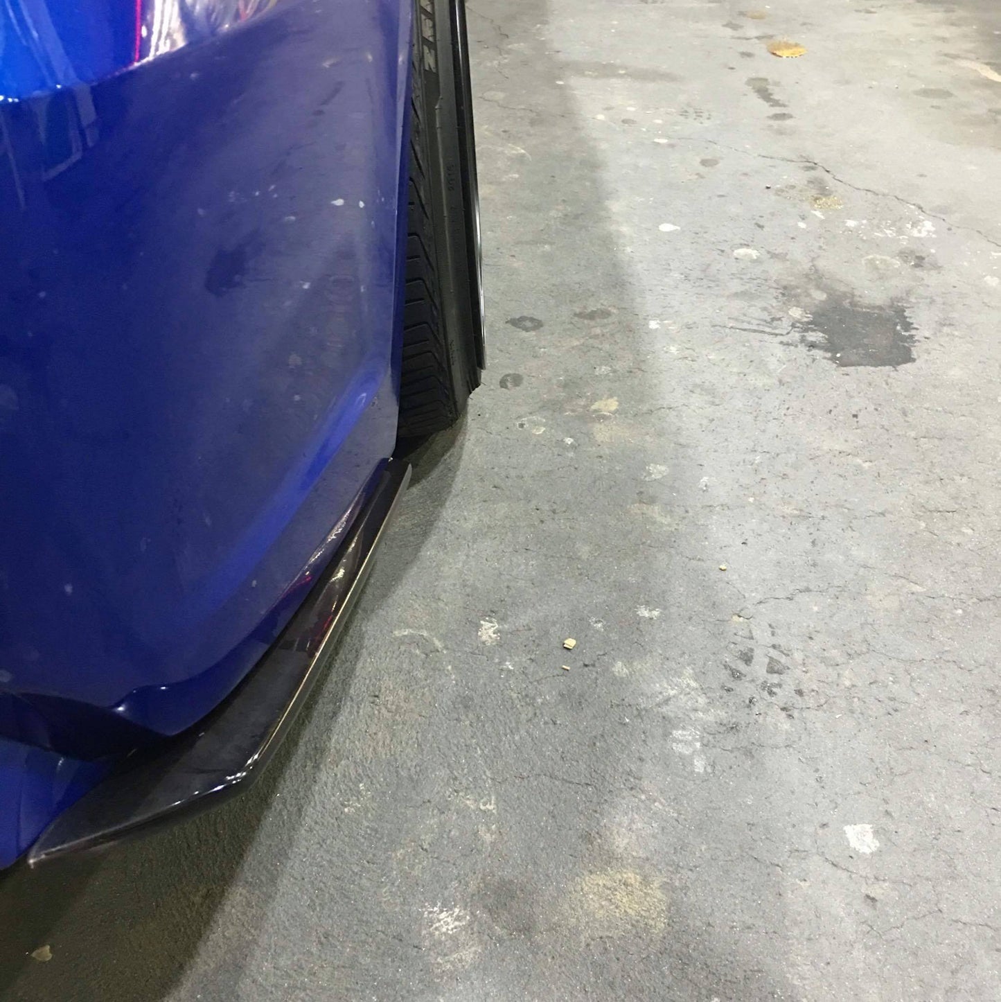 Close-up side skirt extension fitment installed aftermarket body kit detail on car