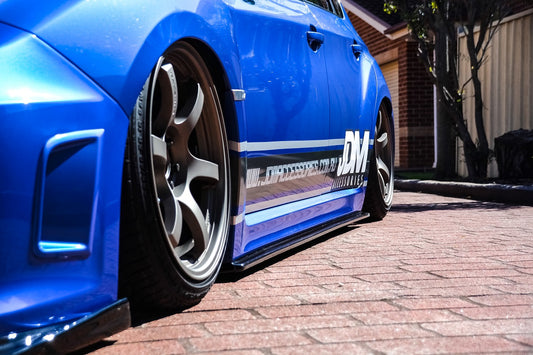 Close-up of Subaru Impreza WRX STI GRB GVB with JSAI Aero side extensions installed aftermarket body kit low angle view